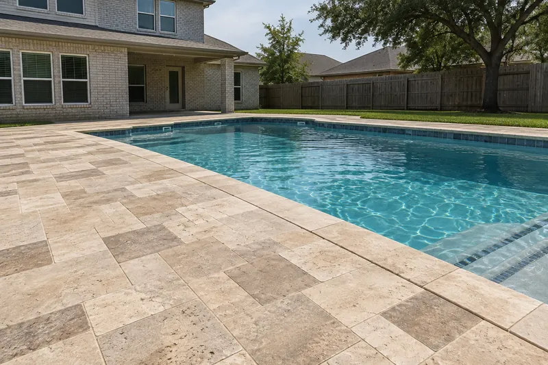 Ivory and walnut travertine pavers laid around a backyard pool